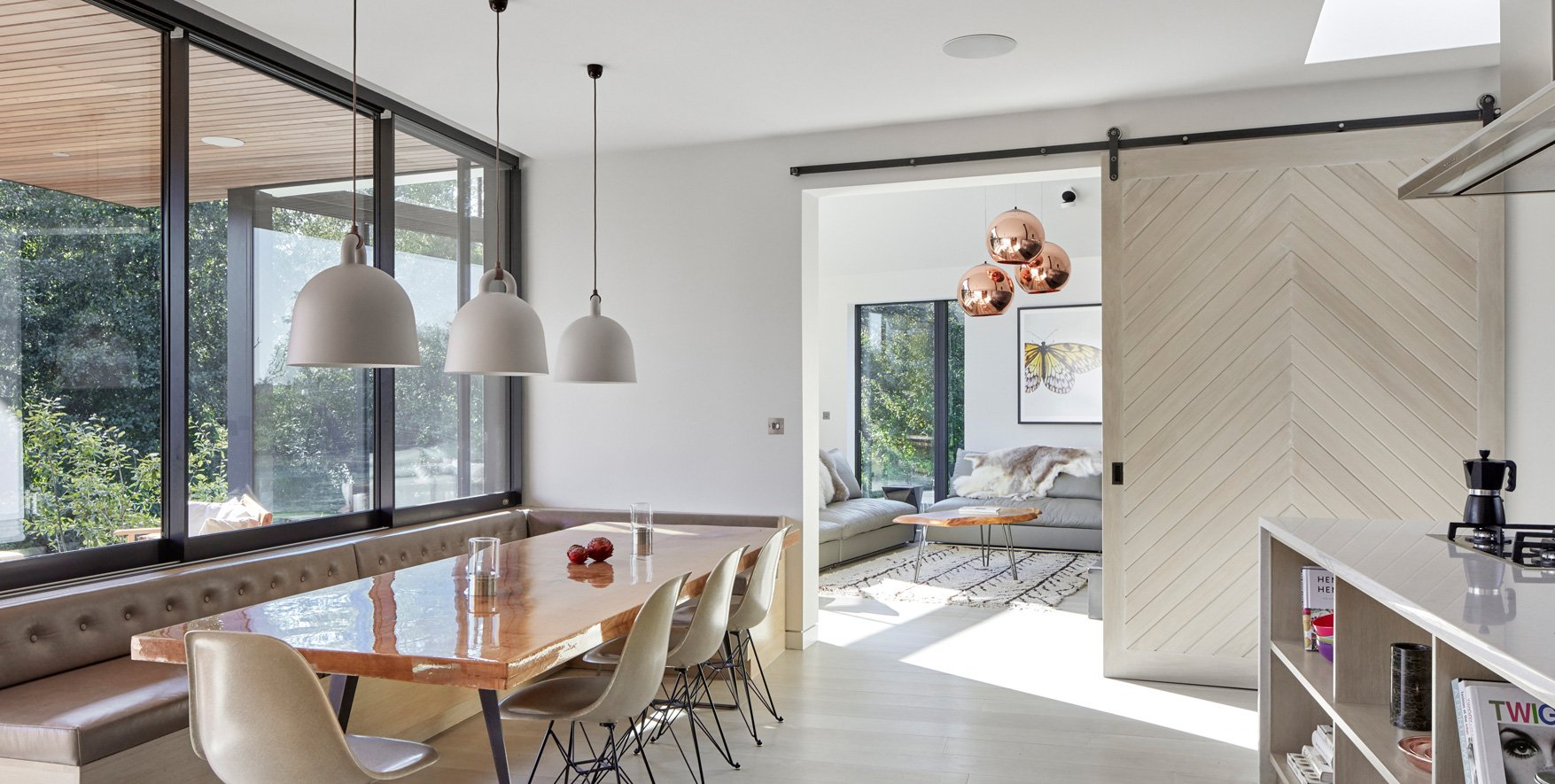 Axel-interior-sliding-barn-door-hardware-in-raw-steel-finish-installed-in-modern-dining-room