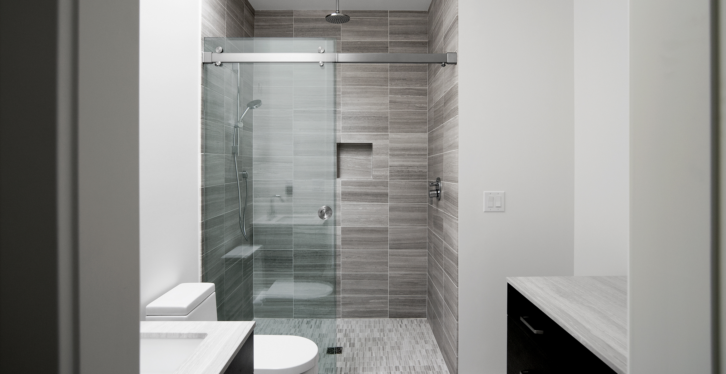 Frameless shower door system in Brushed Stainless finish.