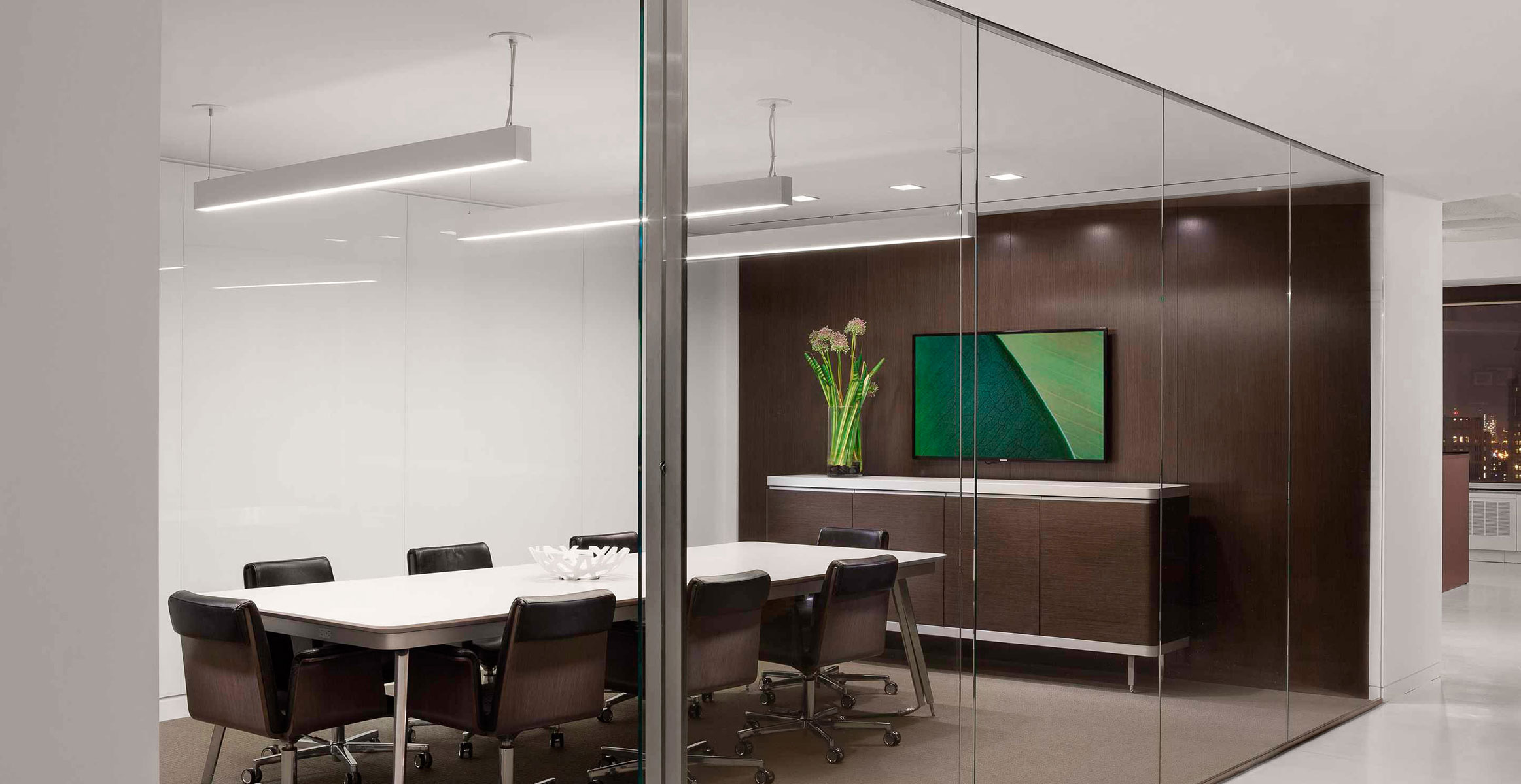 Glass conference room sliding doors with vertical stainless steel pulls