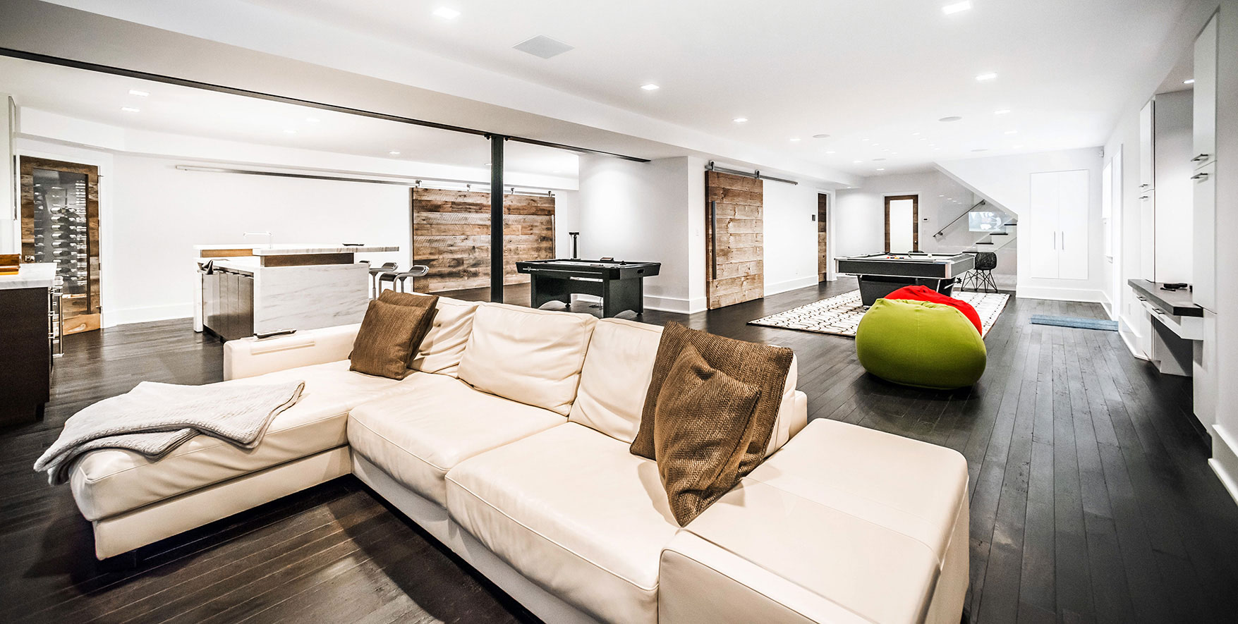 The remodeled basement of a Scarsdale, NY home featuring Krownlab sliding door hardware.
