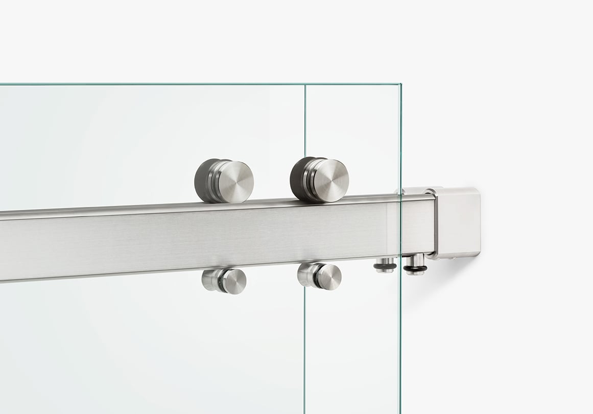 Modern sliding glass shower door hardware in brushed stainless finish by Krownlab for frameless glass.