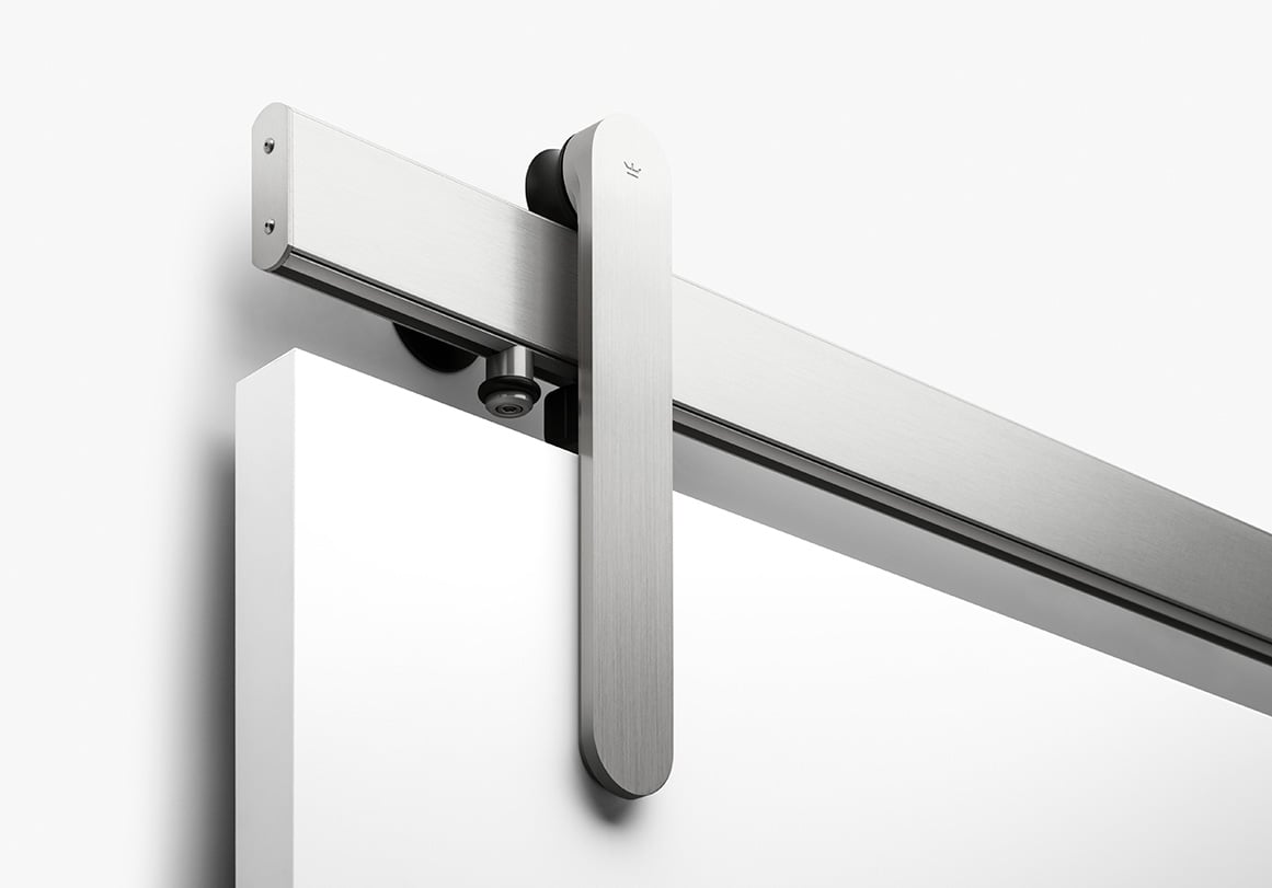 Loki sliding barn door hardware in brushed stainless finish by Krownlab with flat white door.