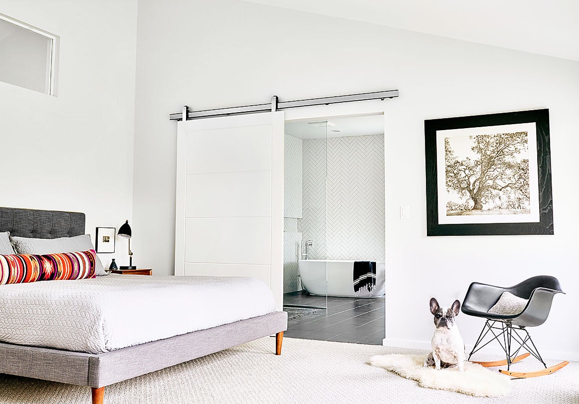 Oden sliding door hardware installed in a modern bedroom. 